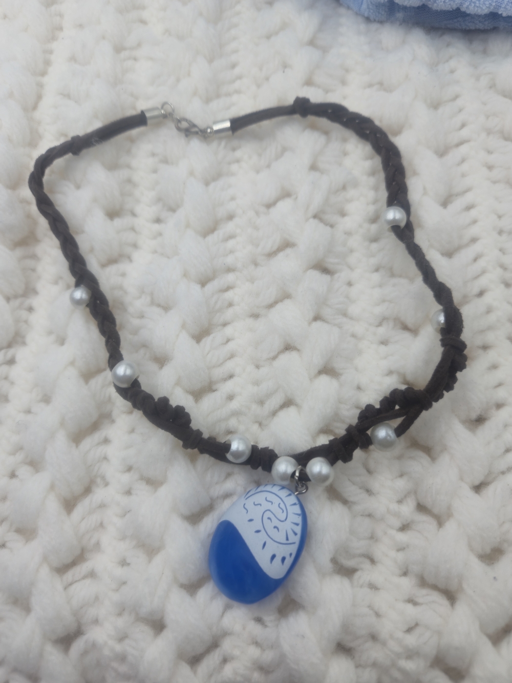 Moana-inspired necklace features a blue "Heart of Te Fiti" pen